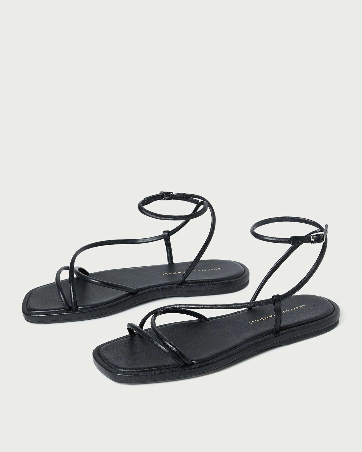 Sandale plate en cuir noir Noor
